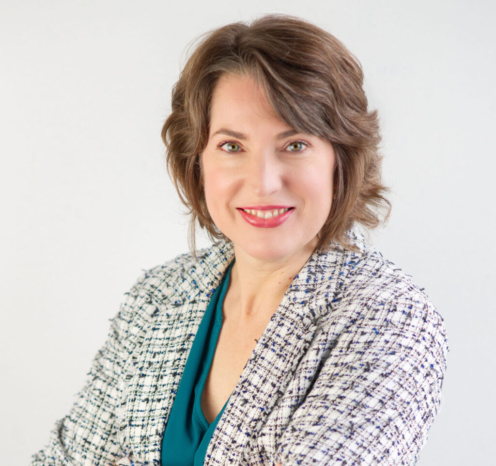 Ariana stands with blazer smiling