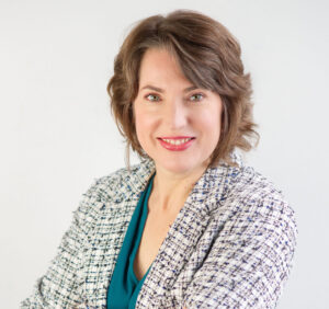 Ariana stands with blazer smiling